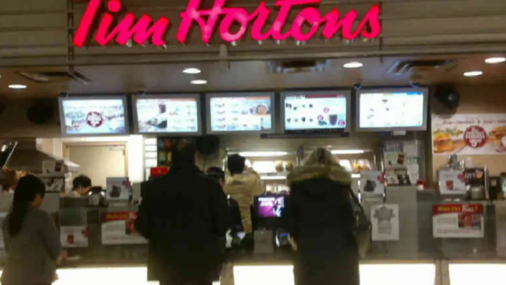 Tim Hortons storefront and interior at 100 King St West, Toronto, ON