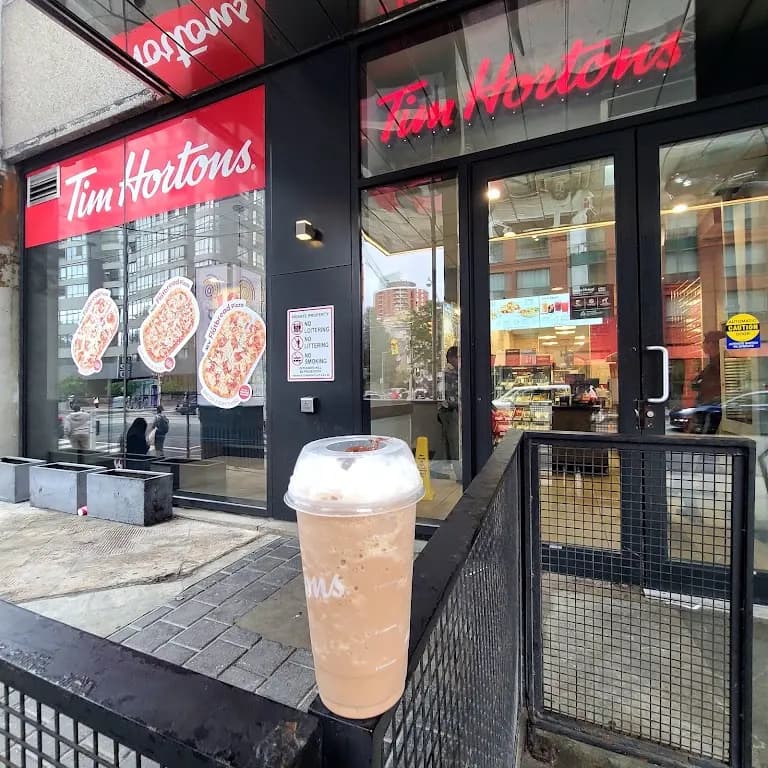 Tim Hortons storefront and interior at 111 Carlton St, Toronto, ON