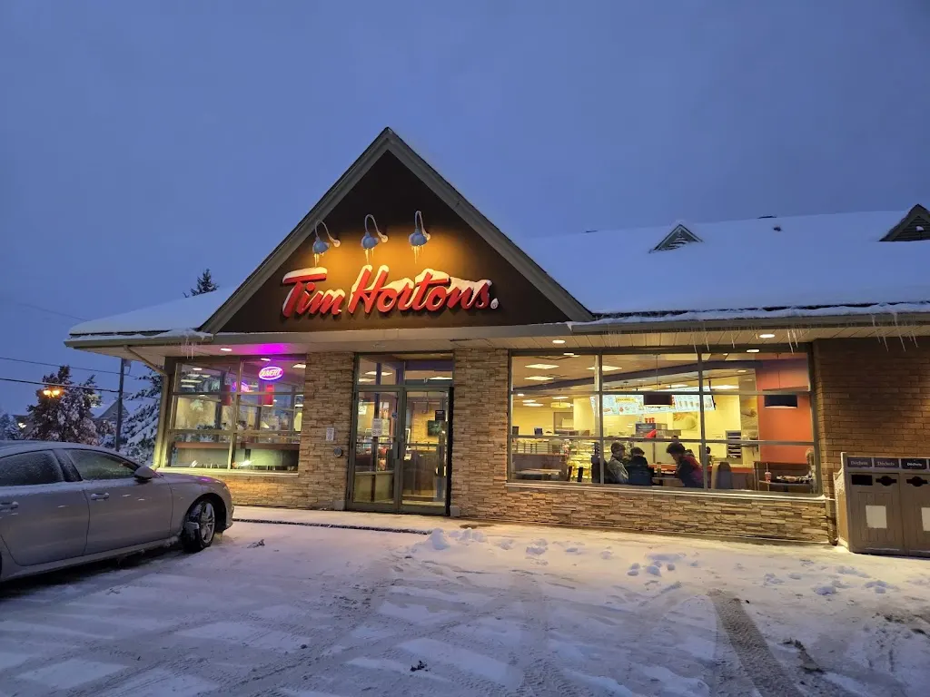 Tim Hortons storefront and interior at 1 Rue St Denis, Bromont, QC